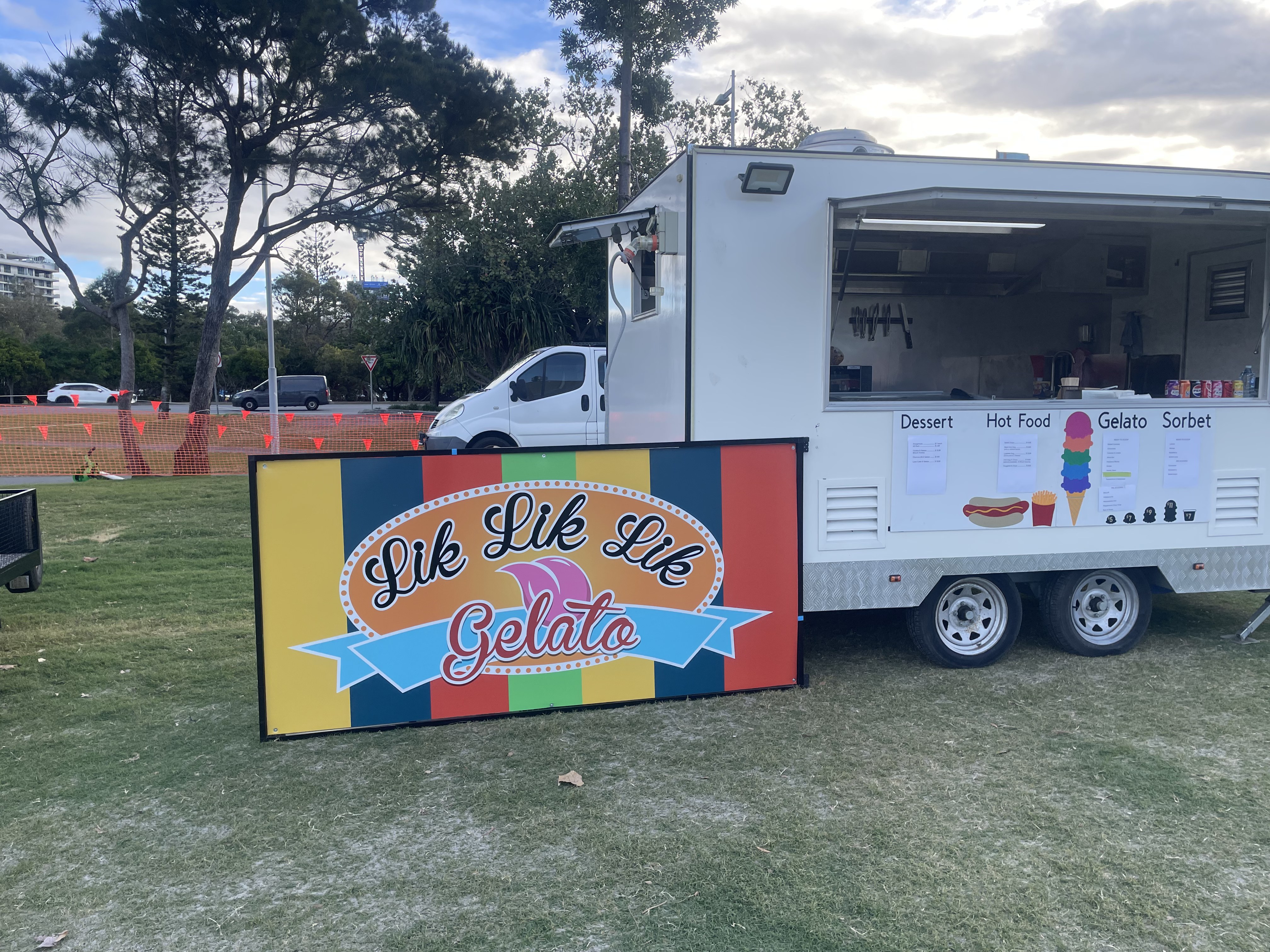 Side view of the Lik Lik Lik trailer serving from an open field